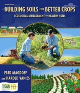 Book cover of Building Soils For Better Crops, showing farmers working in a field