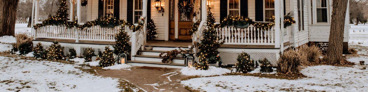 Image of white colonial house with a dusting of snow for holiday note blog